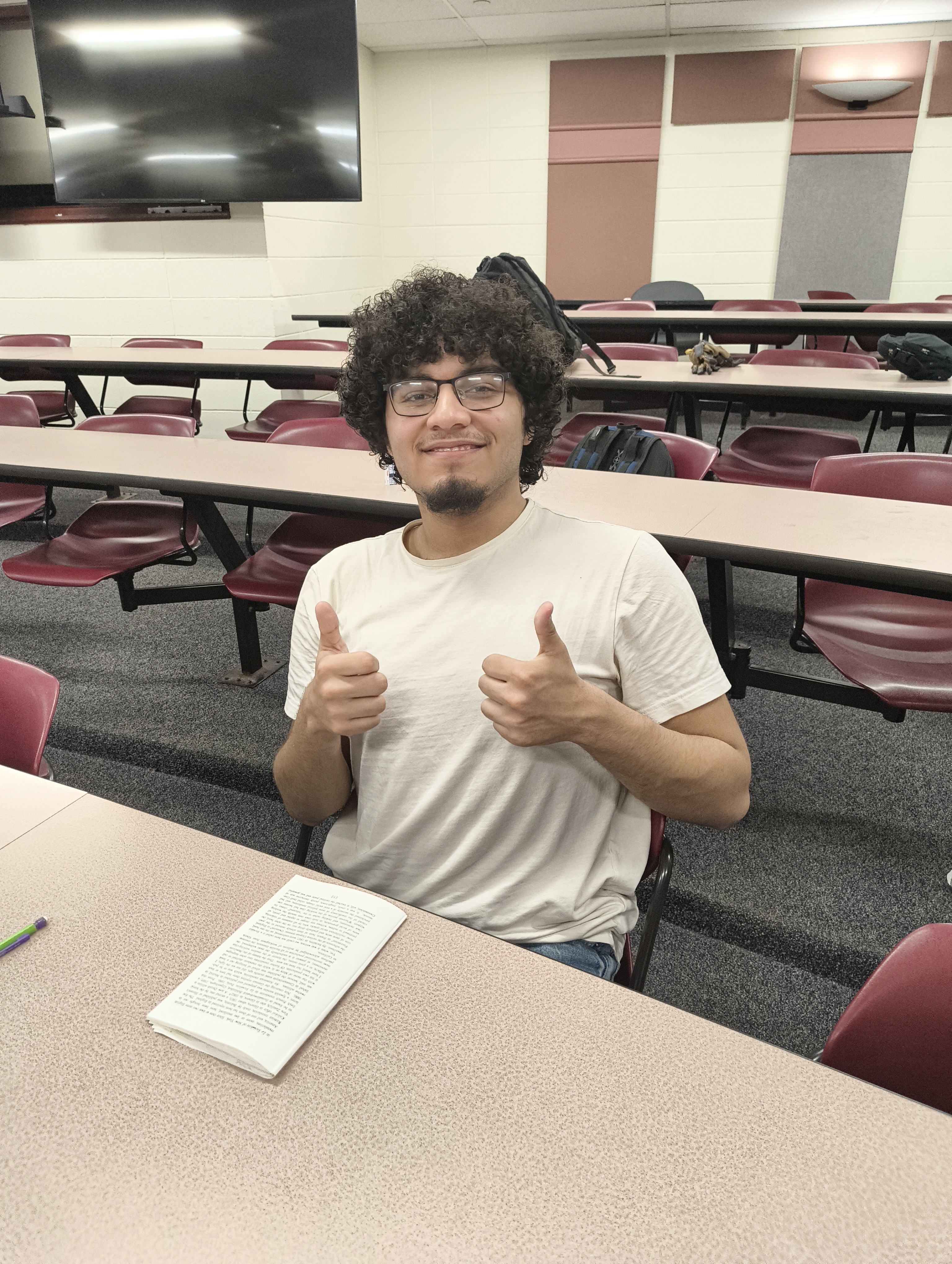 A successful test taker gives a double thumbs up